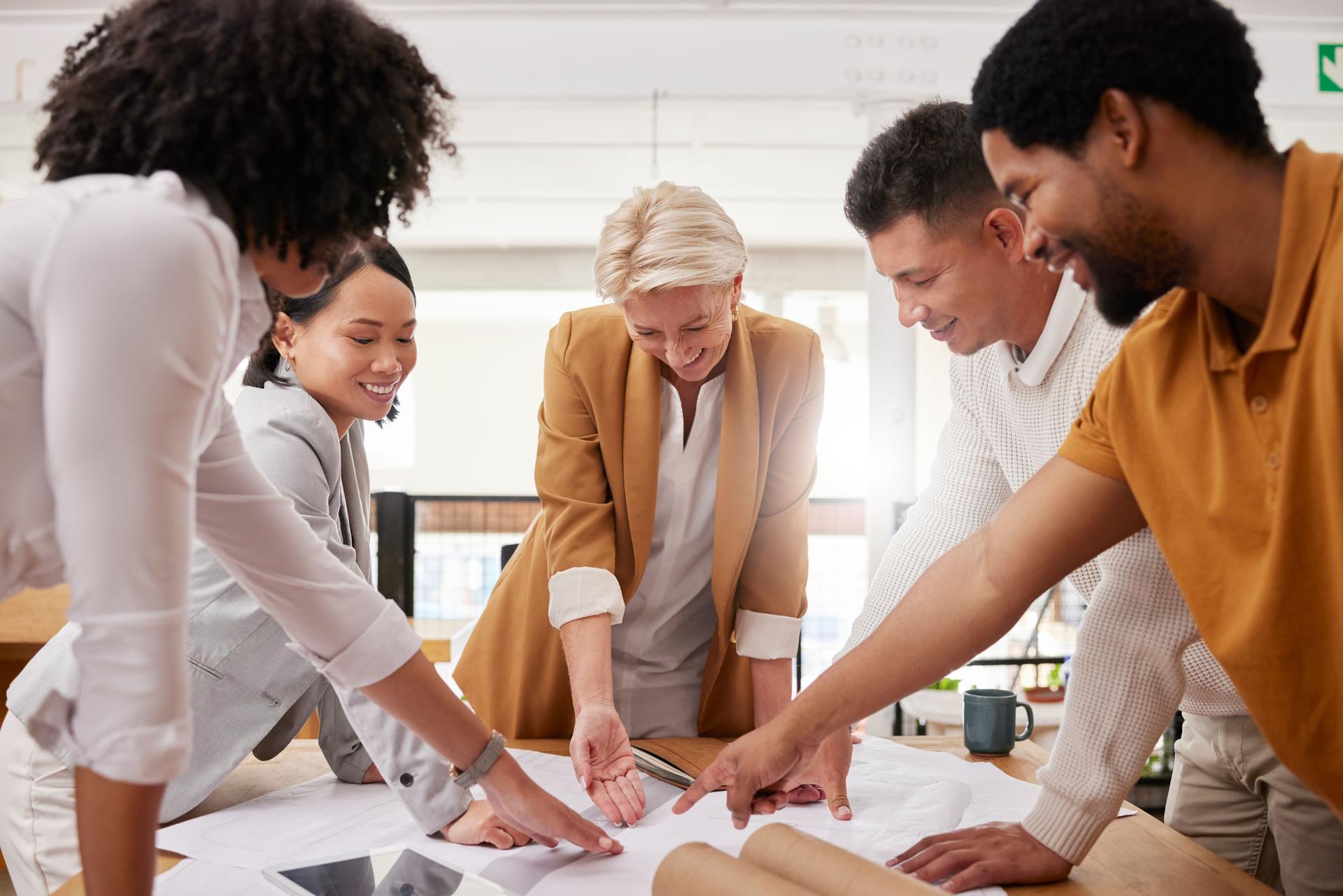 Business people, teamwork and planning blueprint, architecture design and collaboration meeting in office. Happy group of designer, men and women for ideas, floor plan solution or project development