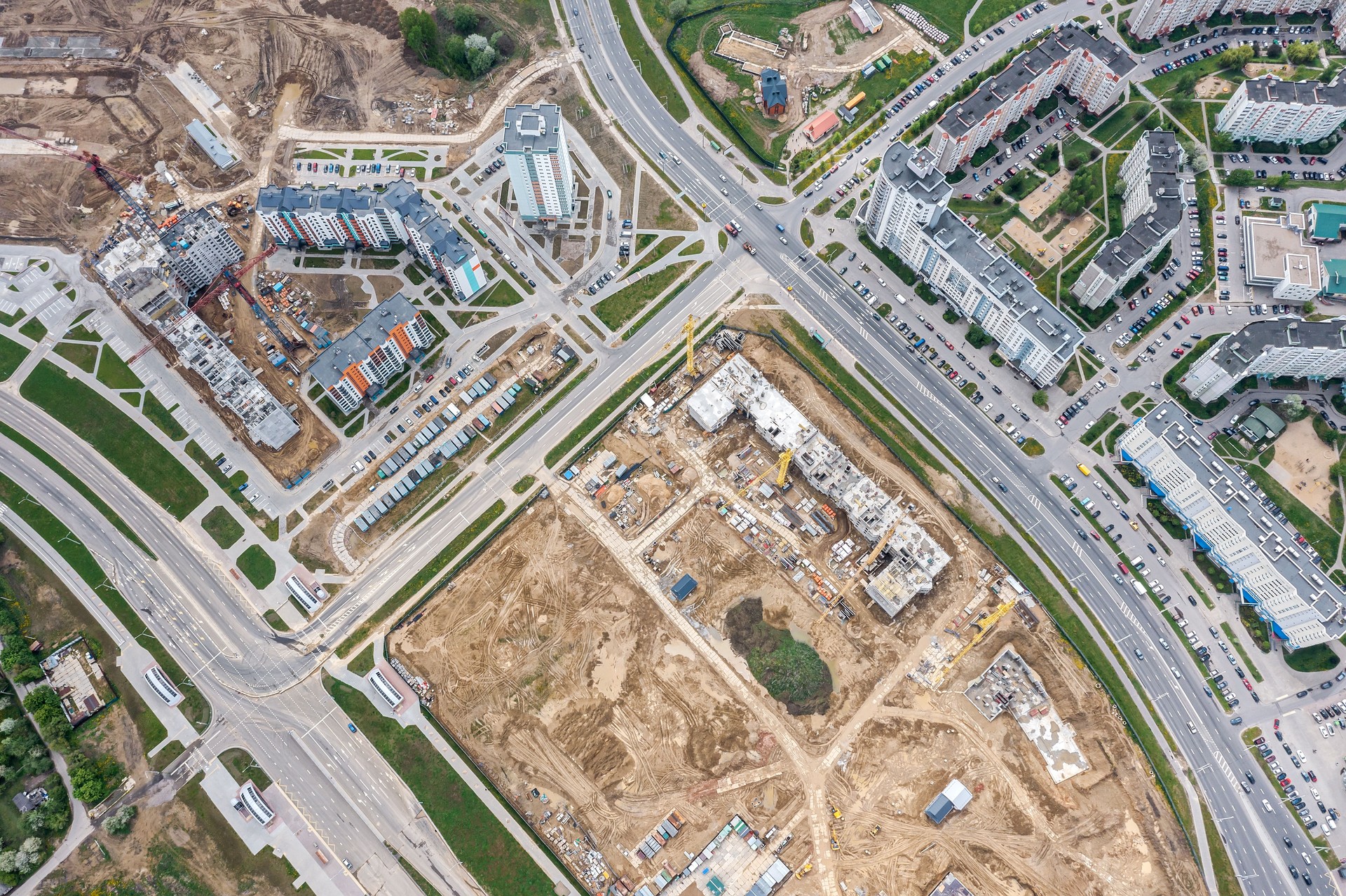 new apartment buildings under construction. development of urban residential district. aerial view from flying drone.