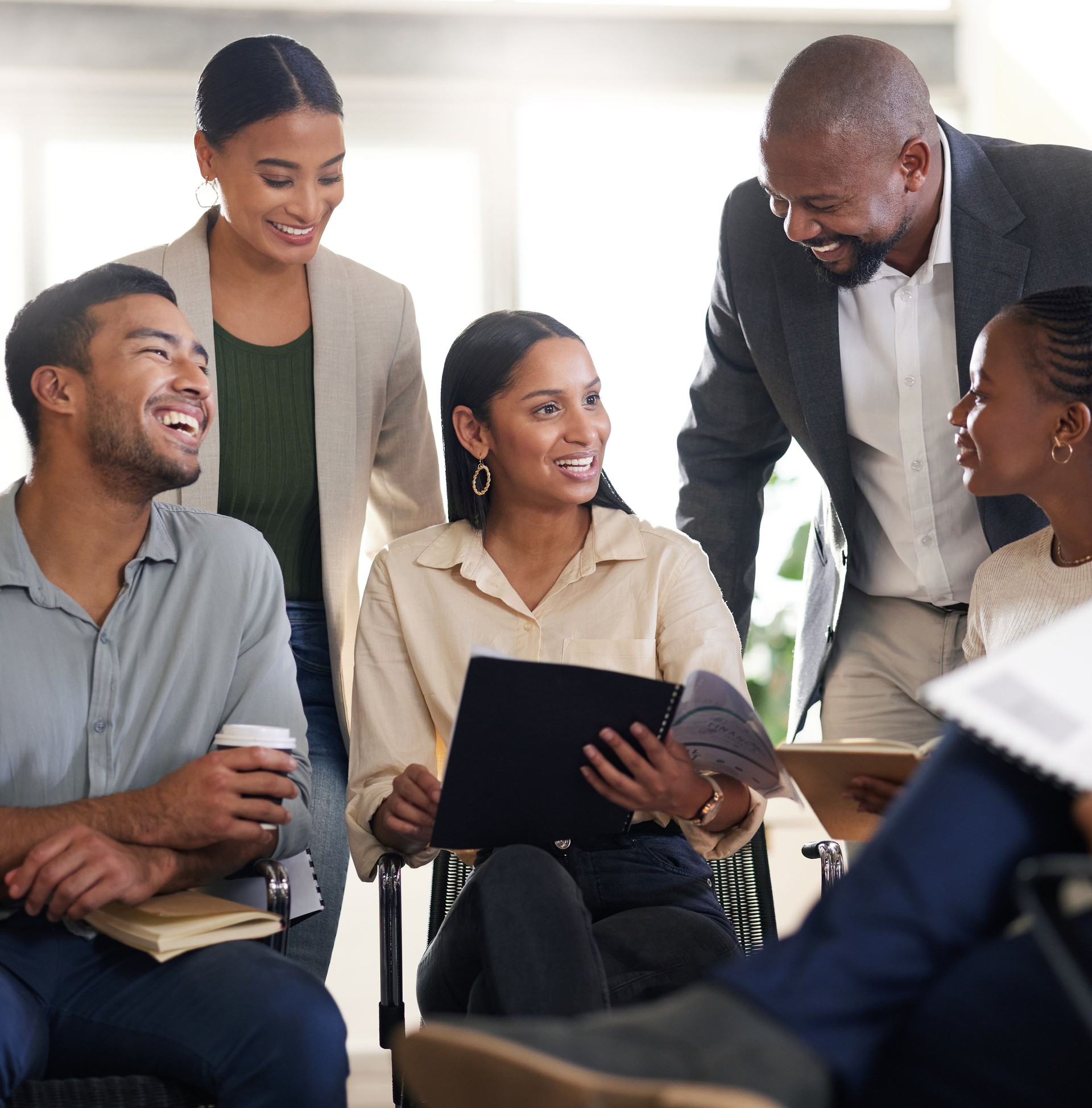 Cropped shot of a diverse group of businesspeople sitting in the boardroom during a meeting